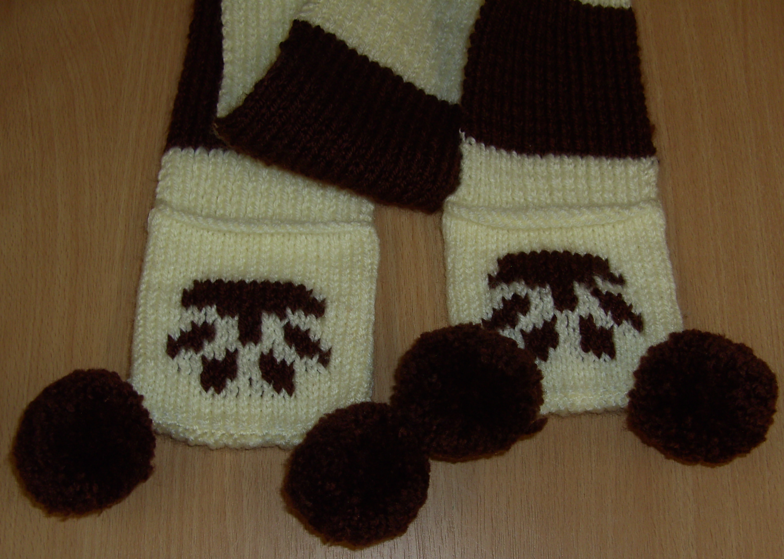 Striped white and brown knitted dog paw print scarf with pom poms knitsrus